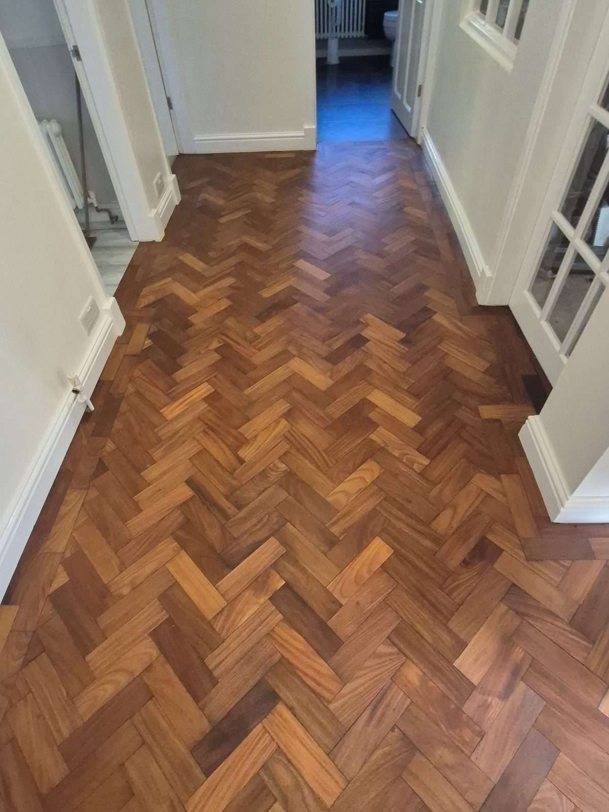 Iroko herringbone parquet hallway after refinishing with Arboritec Miracle Oil 2K in Neutral