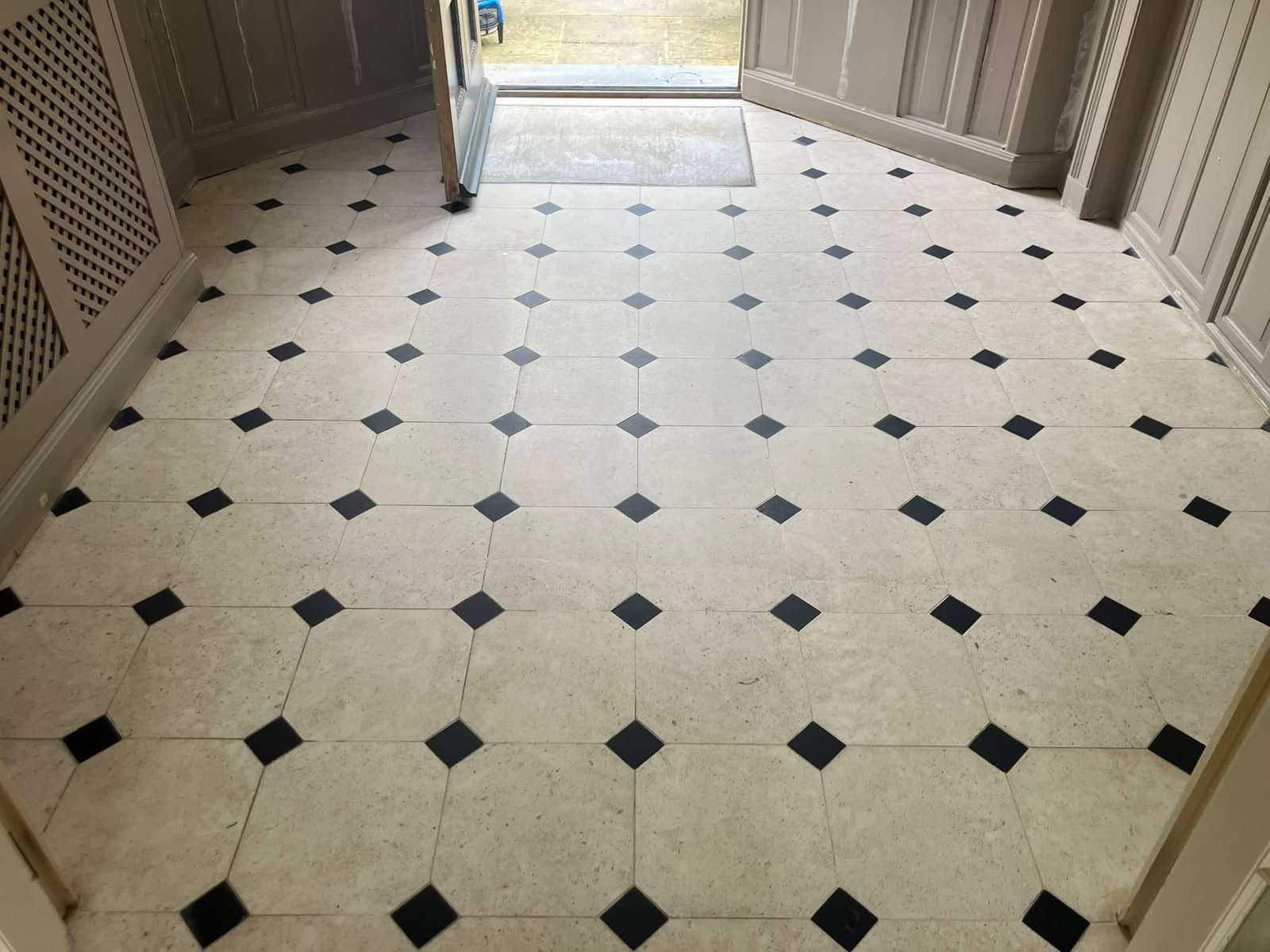 The same limestone entrance hall after restoration by Stonelab, clean and even with the crack filled