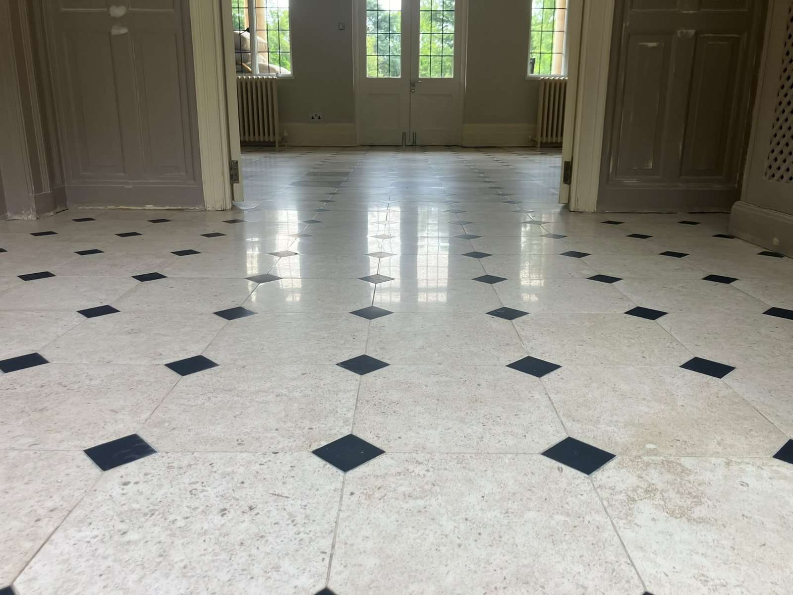 Low angle view of the restored limestone floor showing its even sheen and reflections
