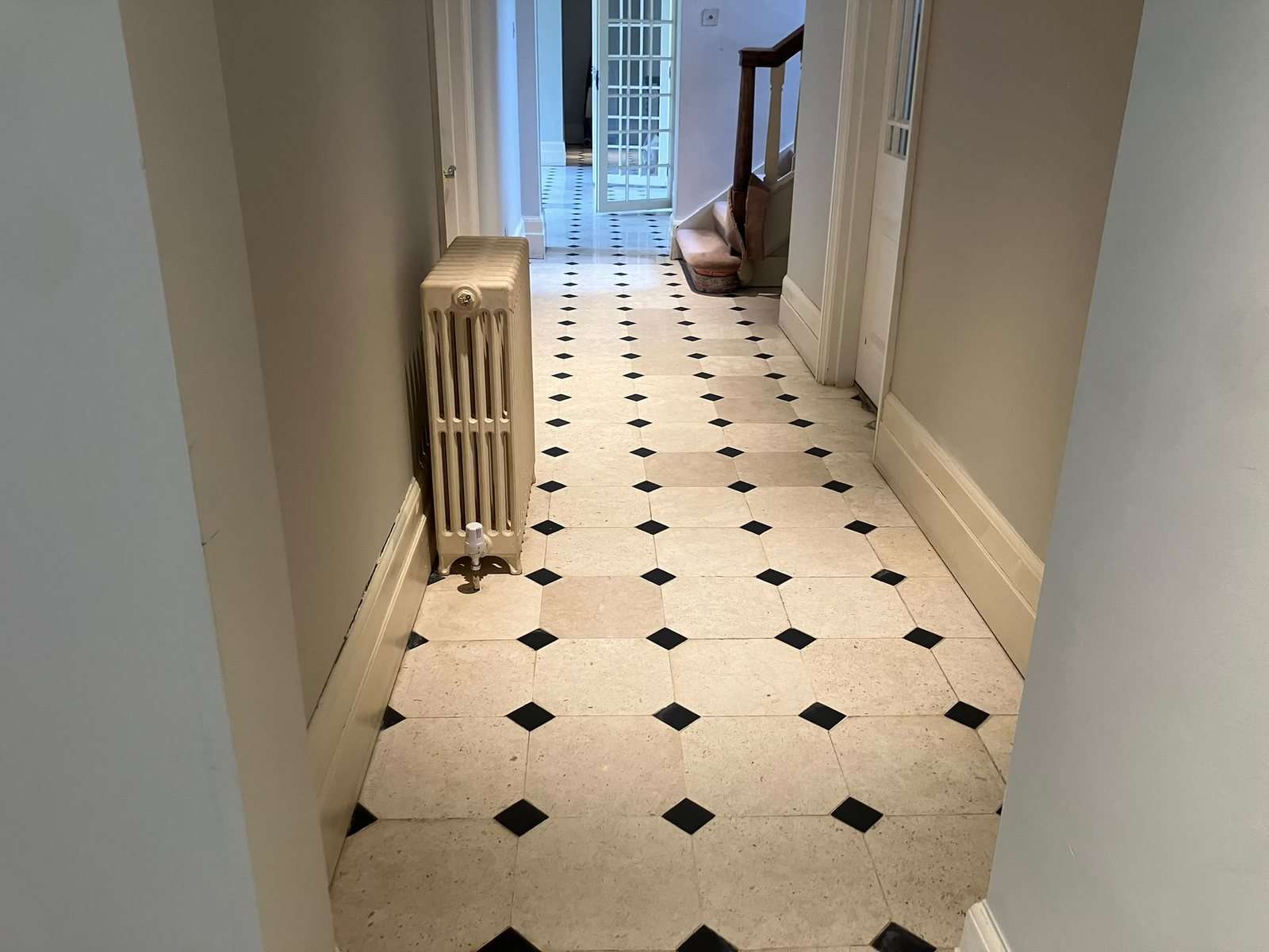 The same limestone hallway after glue removal, grinding and sealing by Stonelab